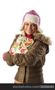 very cute blond girl in winter dress with hat and gloves and shopping christmas bag