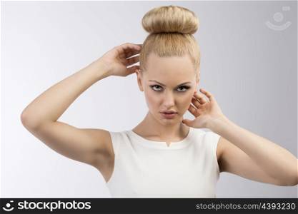 very cute blond woman with white dress and hair-style on gray background