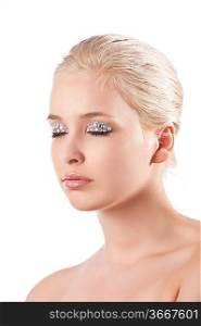 very cute blond young woman with hair style with some shining gem stone on her eyes as a creative make up