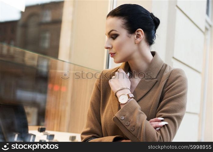 very cute brunette girl going for shop in a winter day . she is standing at the windoe shop&#xA;