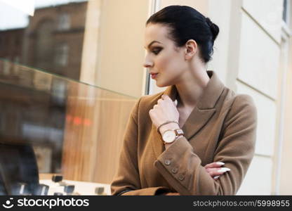 very cute brunette girl going for shop in a winter day . she is standing at the windoe shop&#xA;