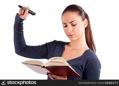 very cute young student college in casual dress reading book and in act to write