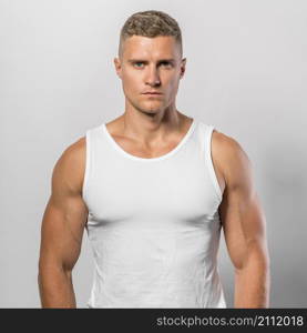 very fit man posing while wearing tank top