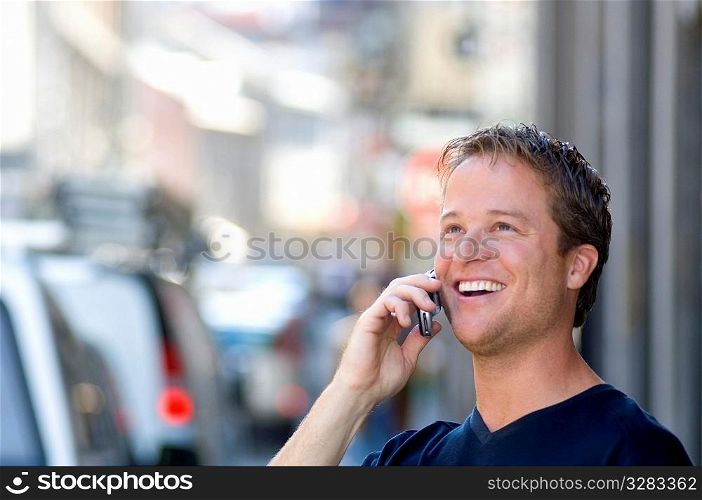 Very happy man talking his cellular phone.