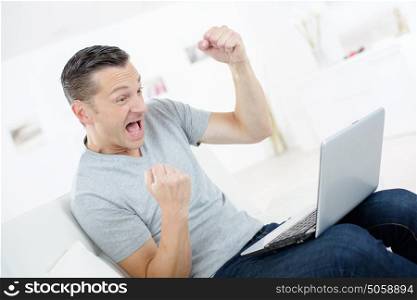 very happy man with laptop