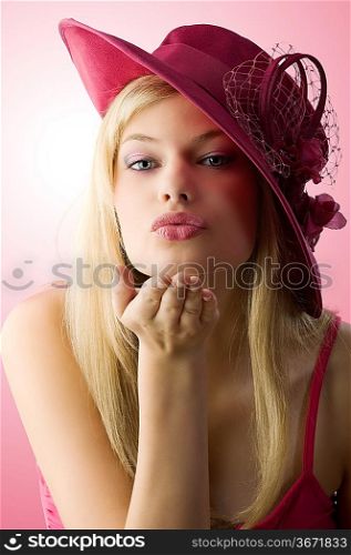 very nice girl with blue eyes and red hat giving a virtual kiss