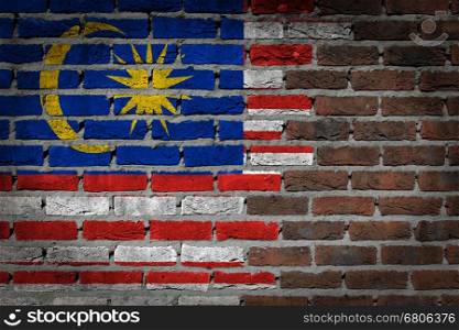 Very old dark red brick wall texture with flag - Malaysia