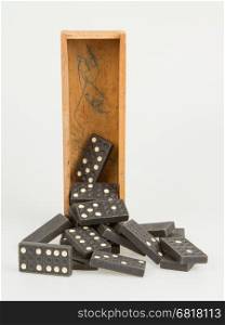 Very old domino in wooden box against the white background