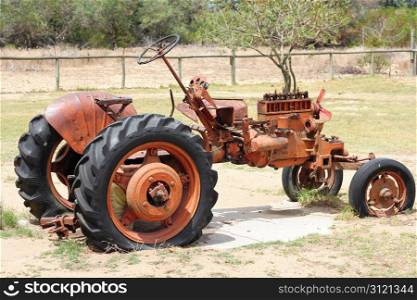 Very old red tractor on a farm