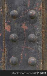 Very old rivets, detail of an iron railway bridge.