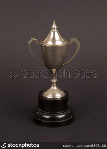 Very old trophy cup isolated on a black background