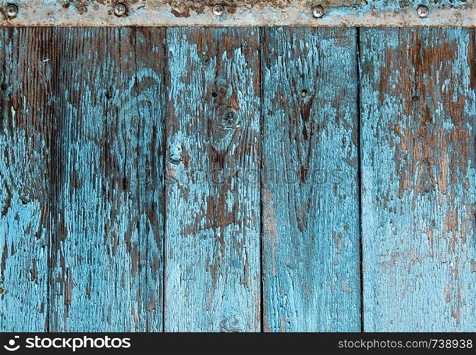 very old wooden background with blue cracked paint, parallel boards, full frame