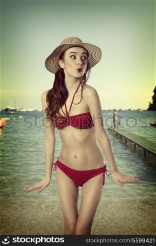 very sexy nice girl in red bikini in funny pose with a simmer hat . old fashion color. Summer time