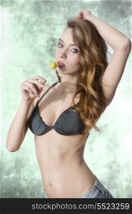 very sexy woman wearing swimwear, posing with wavy long hair and eating lollipop