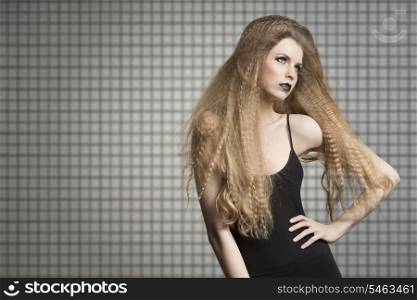 very sexy young girl with long blonde creative hair-style, dark fashion make-up and black dress