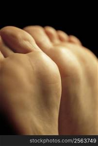 Very shallow depth-of-field image of the bottom of a females feet - possibly waiting for a massage.