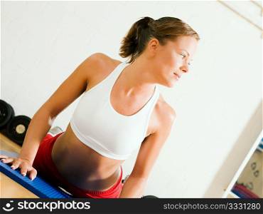 Very sportive woman doing pushups in a gym