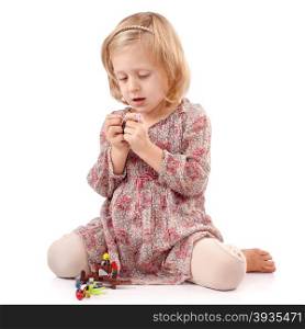 Very thoughtful girl playing with small toys
