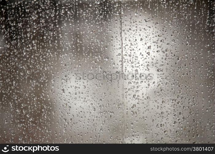 very wet window full of raindrops during downpoar