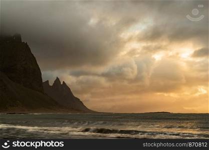 Vestrahorn mountain and ocean at sunrise in a cloudy day, Iceland. Vestrahorn mountain in Iceland