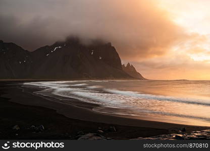 Vestrahorn mountain and the black beach at sunrise in a cloudy day, Iceland. Vestrahorn mountain in Iceland