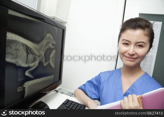 Veterinarian next to animal&rsquo;s x-ray, portrait