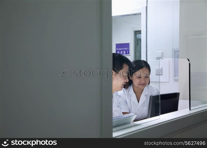 Veterinarians looking at computer screen