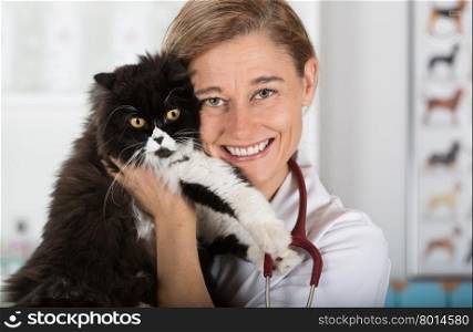Veterinary hugging a cat and reassuring for review