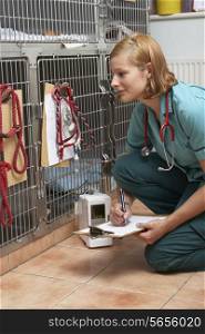 Veterinary Nurse Checking On Animals In Cages