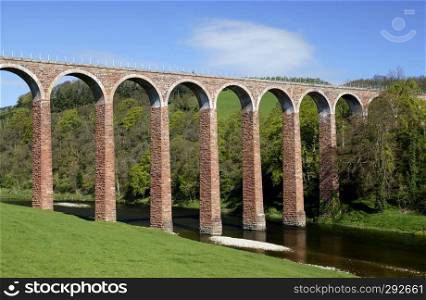 Viaduct near Melrose in Scotland. A viaduct is a bridge composed of several small spans for crossing a valley, this one carries a railway line.                              