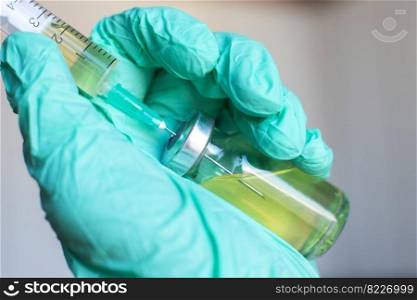 Vial filled with liquid vaccine in medical lab with syringe. doctor&rsquo;s hand holds medical ampoule and syringe. Vial filled with liquid vaccine in medical lab with syringe.doctor&rsquo;s hand holds ampoule and syringe