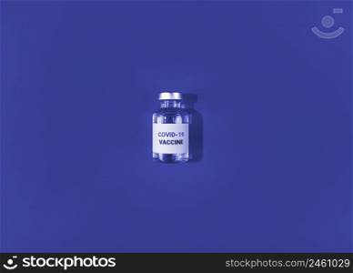 Vial with covid 19 vaccine on a blue background. Medical simple flat lay.. Vial with covid 19 vaccine on blue background. Medical simple flat lay.