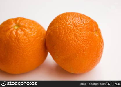 Vibrant mandarin fruit on a white background.