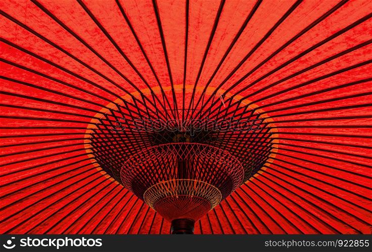 Vibrant red colour vintage retro traditional Japanese or asian paper cotton parasol umbrella background