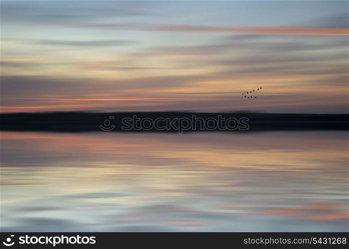 Vibrant sunset with added blur for abstract effect. Blur abstract sunset landscape vibrant colors
