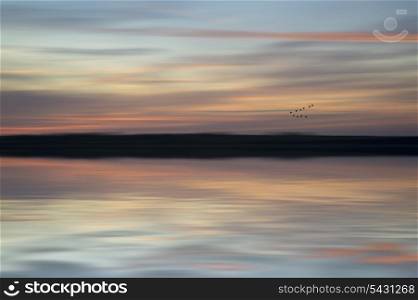 Vibrant sunset with added blur for abstract effect. Blur abstract sunset landscape vibrant colors