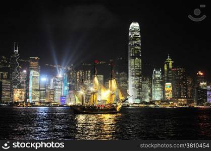 Victoria harbor with famous traditional Chinese junk at night. Hong Kong