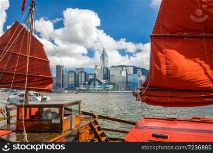 Victoria Harbour and Hong Kong skyline with vintage ship in China
