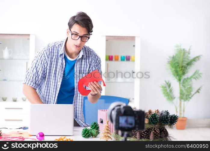 Video blogger recording making paper decoration