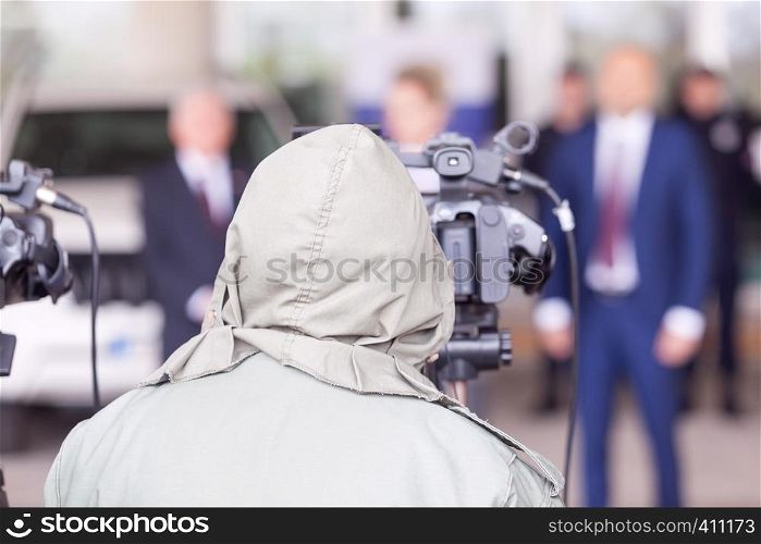Video camera operator working at press conference