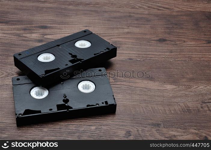 Video cassettes isolated on a wooden background