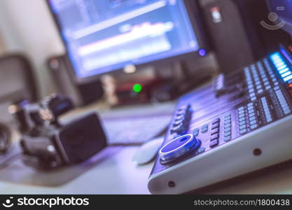 Video editing, recording and cutting room with monitors, camera and sound mixing desk