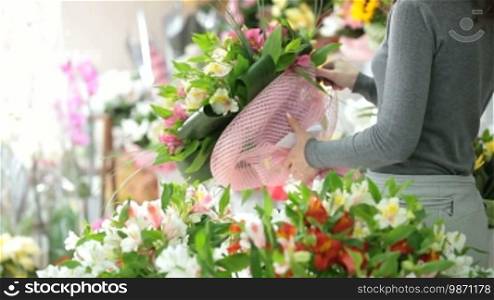 A man buying a bunch of flowers in a florist shop