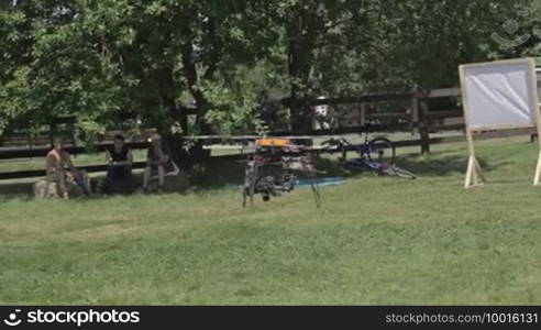 A remote controlled flying craft. Helicopter for aerial photo and video is flying and landing.