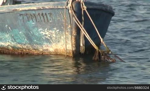 A small boat is fixed on a mooring.