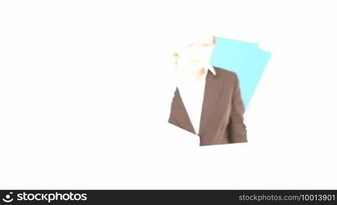 A woman peers through a hole in a sheet of blank white paper which fills the frame.