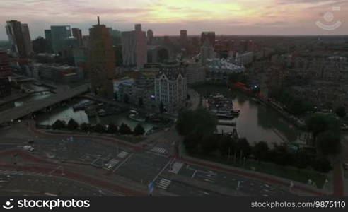 Aerial - Cityscape of Rotterdam with view to the White House, Cube Houses, Markthal and transport traffic. Evening scene in Netherlands