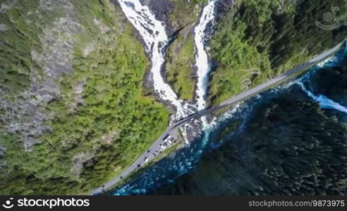 Aerial footage Latefossen Waterfall Odda Norway. Latefoss is a powerful, twin waterfall. View from the bird's-eye view. 

Formatted:
Aerial footage of Latefossen Waterfall in Odda, Norway. Latefoss is a powerful twin waterfall. View from a bird's-eye view.