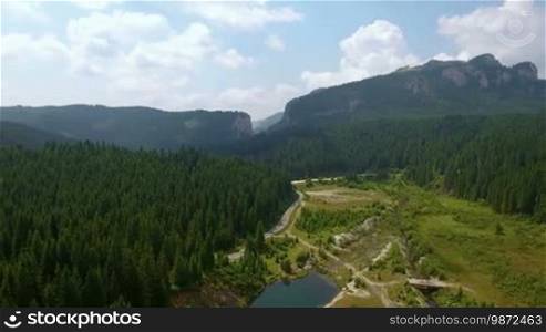 Aerial footage of the mountain ridge covered with forest. Mountain landscape.