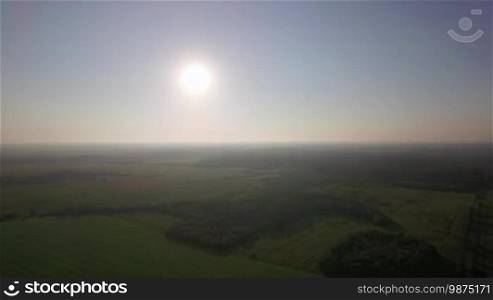 Aerial landscape with green woods and fields. Vast expanses of Russian nature in the light of bright shining sun